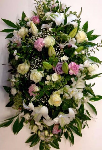 The lily embrace casket spray