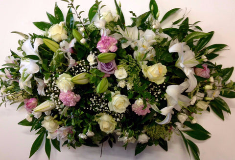 The lily embrace casket spray